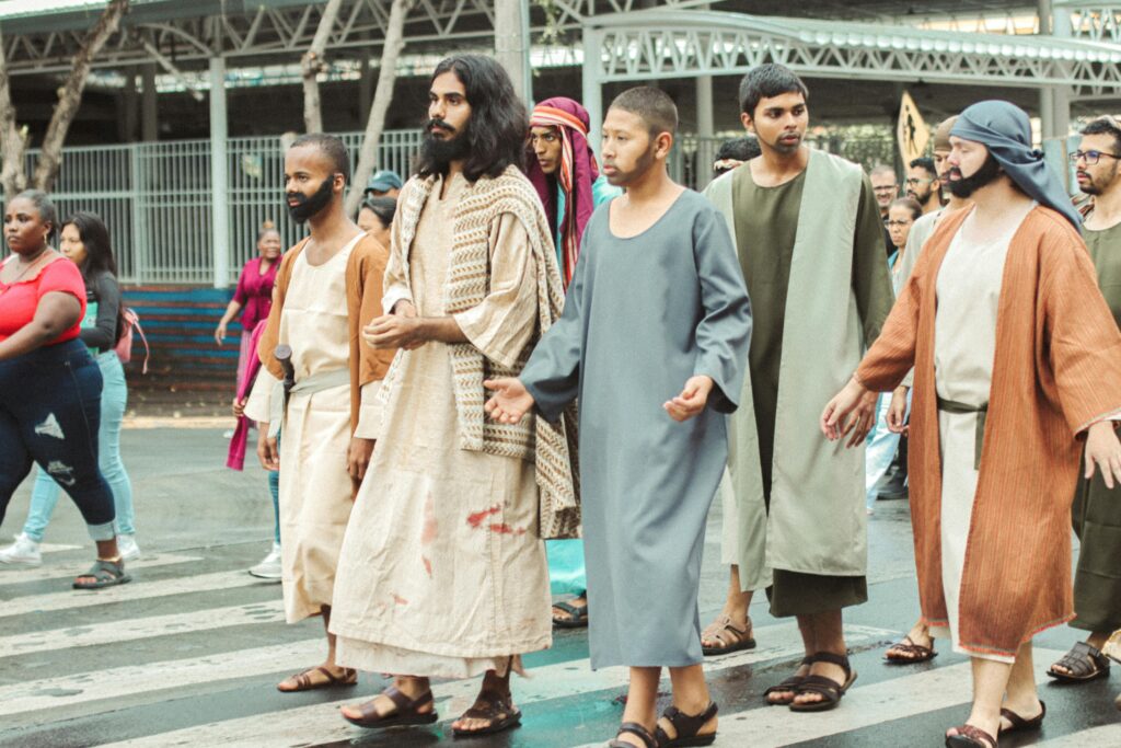 Live reenactment of biblical disciples walking through city streets.
